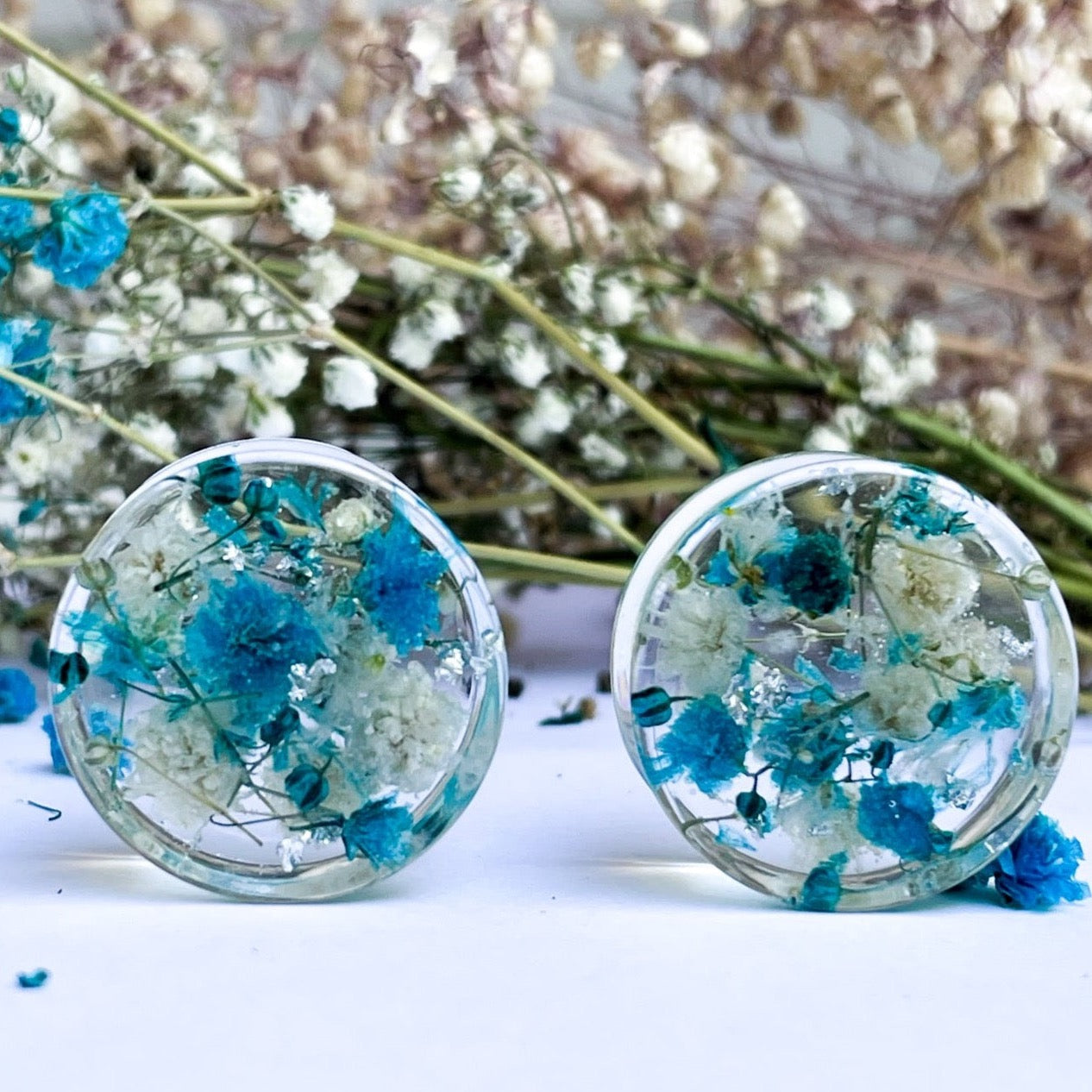 Blue and white flower ear gauges