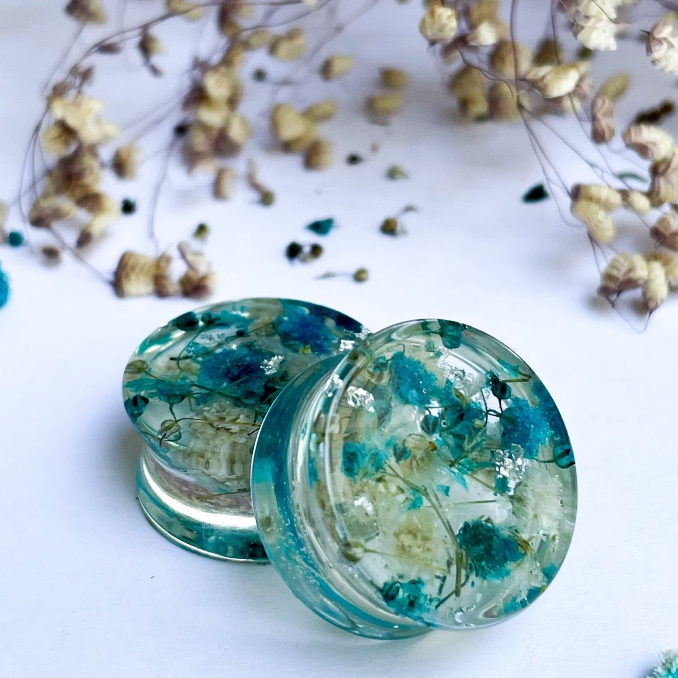 Blue and white flower ear gauges