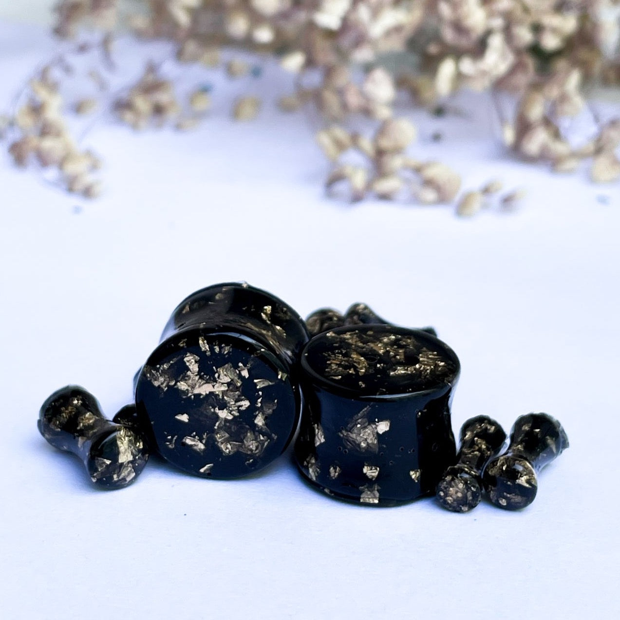 Black and gold colour ear gauges