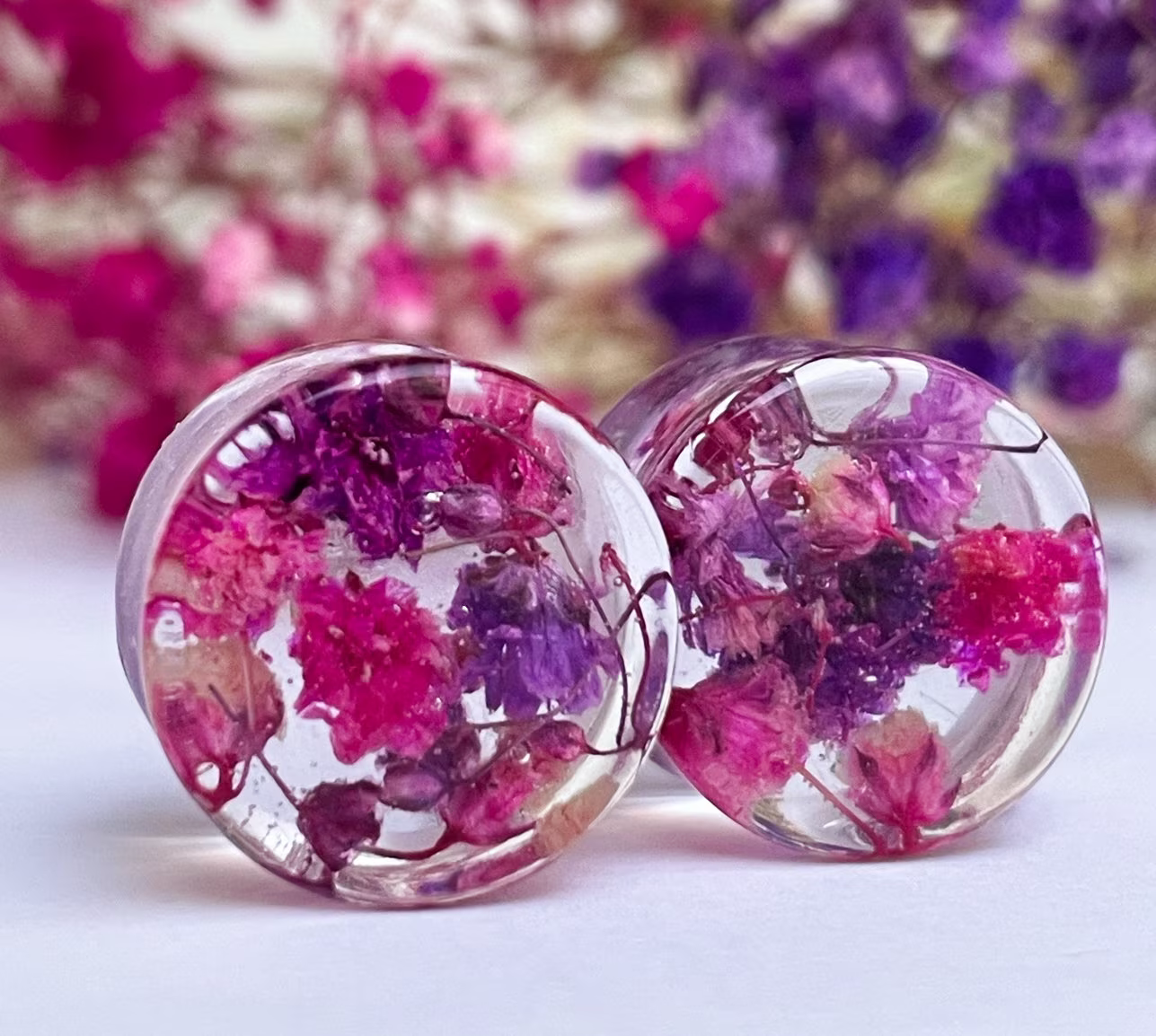 Pink and purple ear gauges