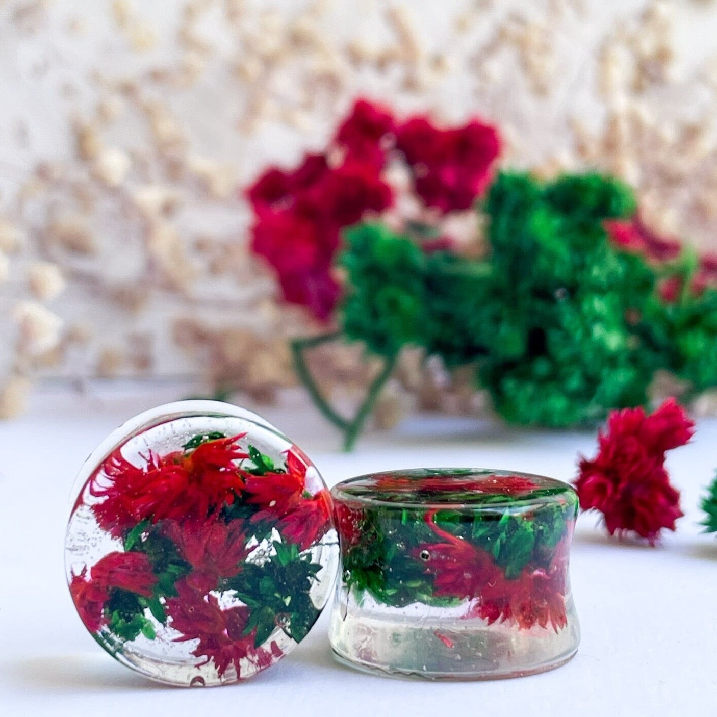 Red and Green flower ear gauges