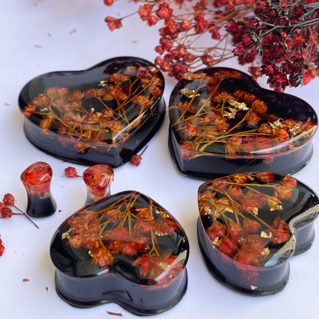 Orange flowers with black background heart shape ear gauges