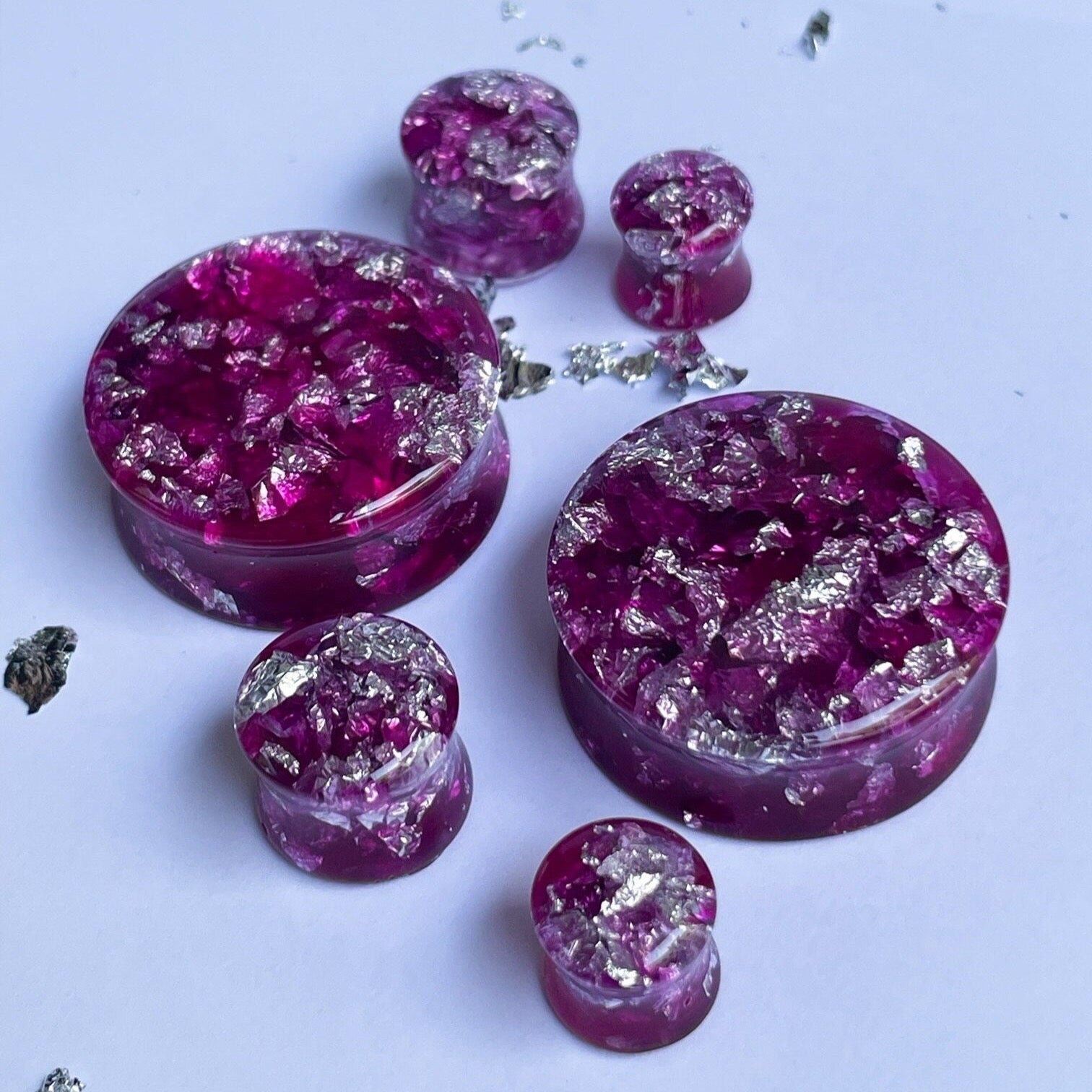 Dark pink resin ear gauges with gold colour flakes