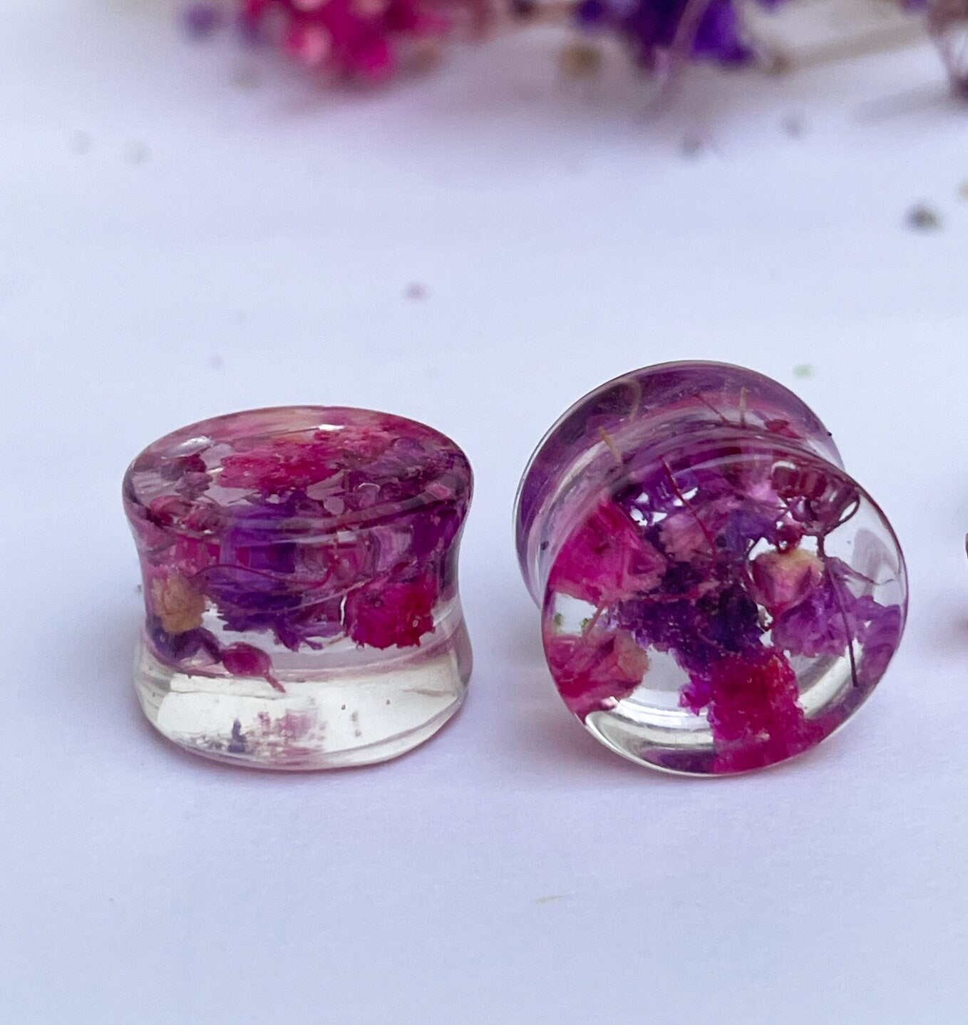 Pink and purple ear gauges