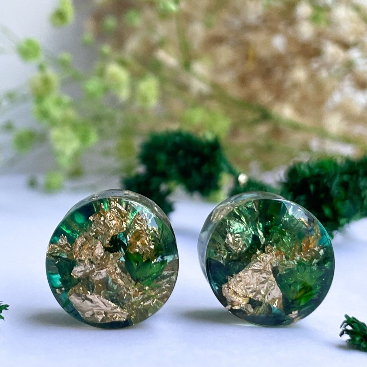 Gold flake and green colour ear gauges