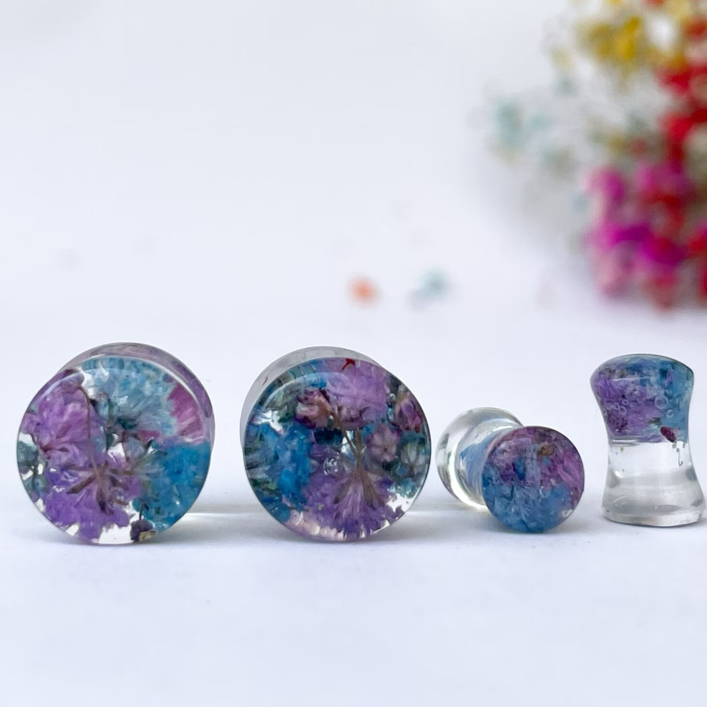 Blue and purple flower ear gauges