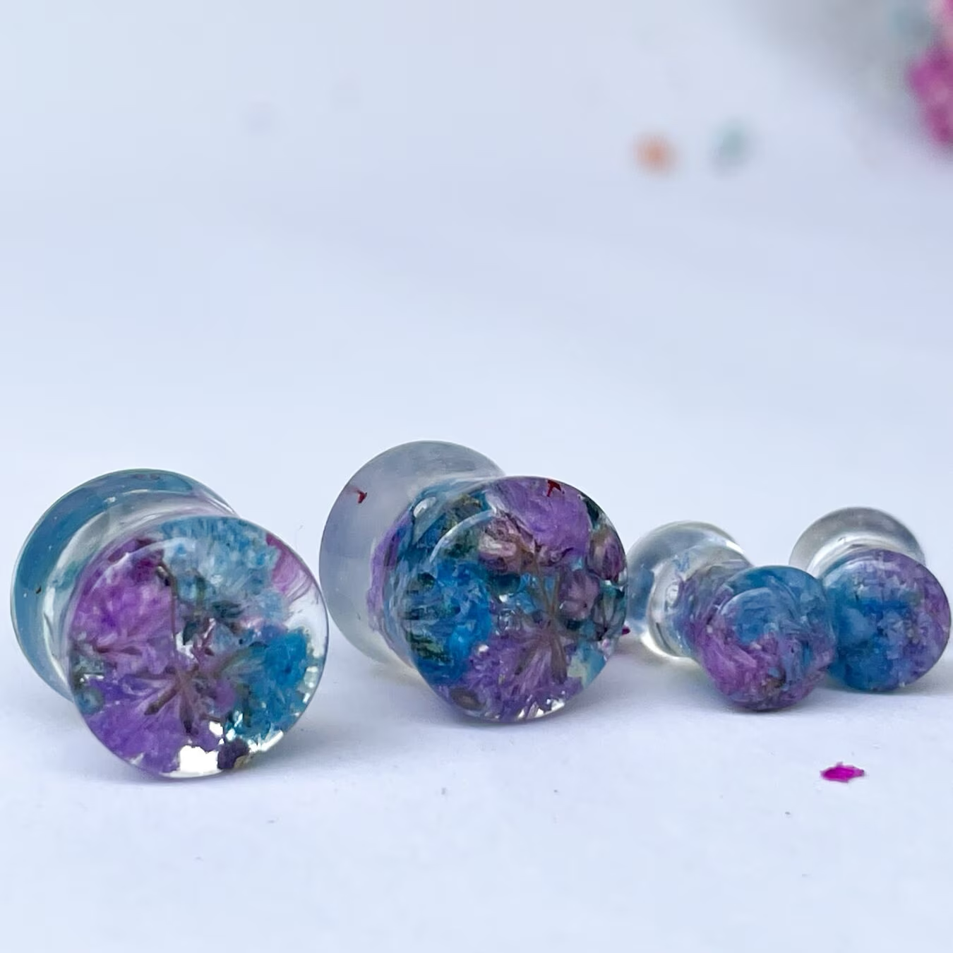 Blue and purple flower ear gauges