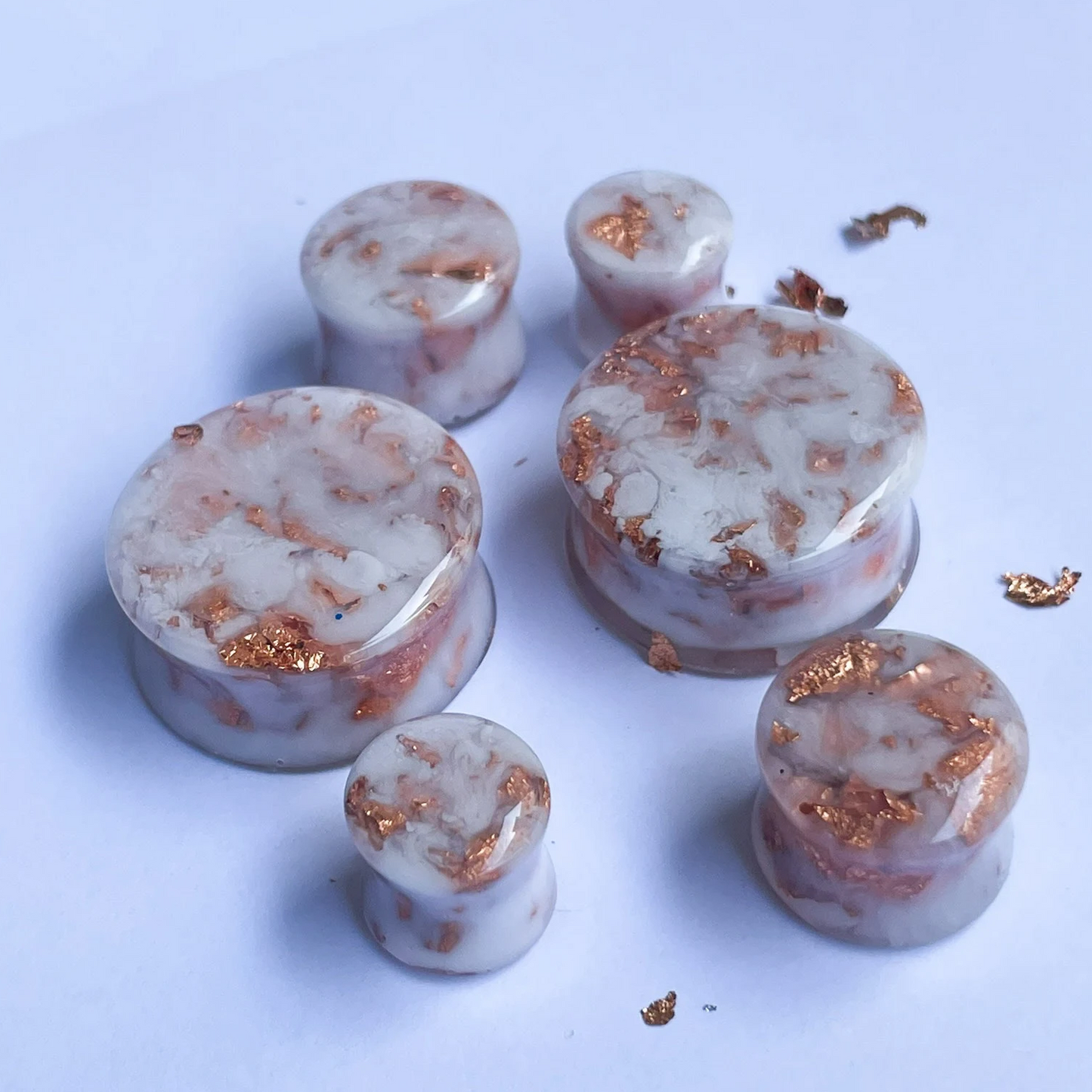 White resin ear gauges with cooper colour flakes