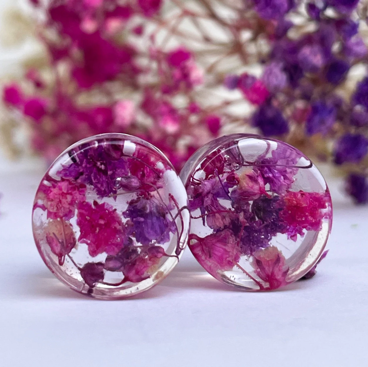 Pink and purple ear gauges