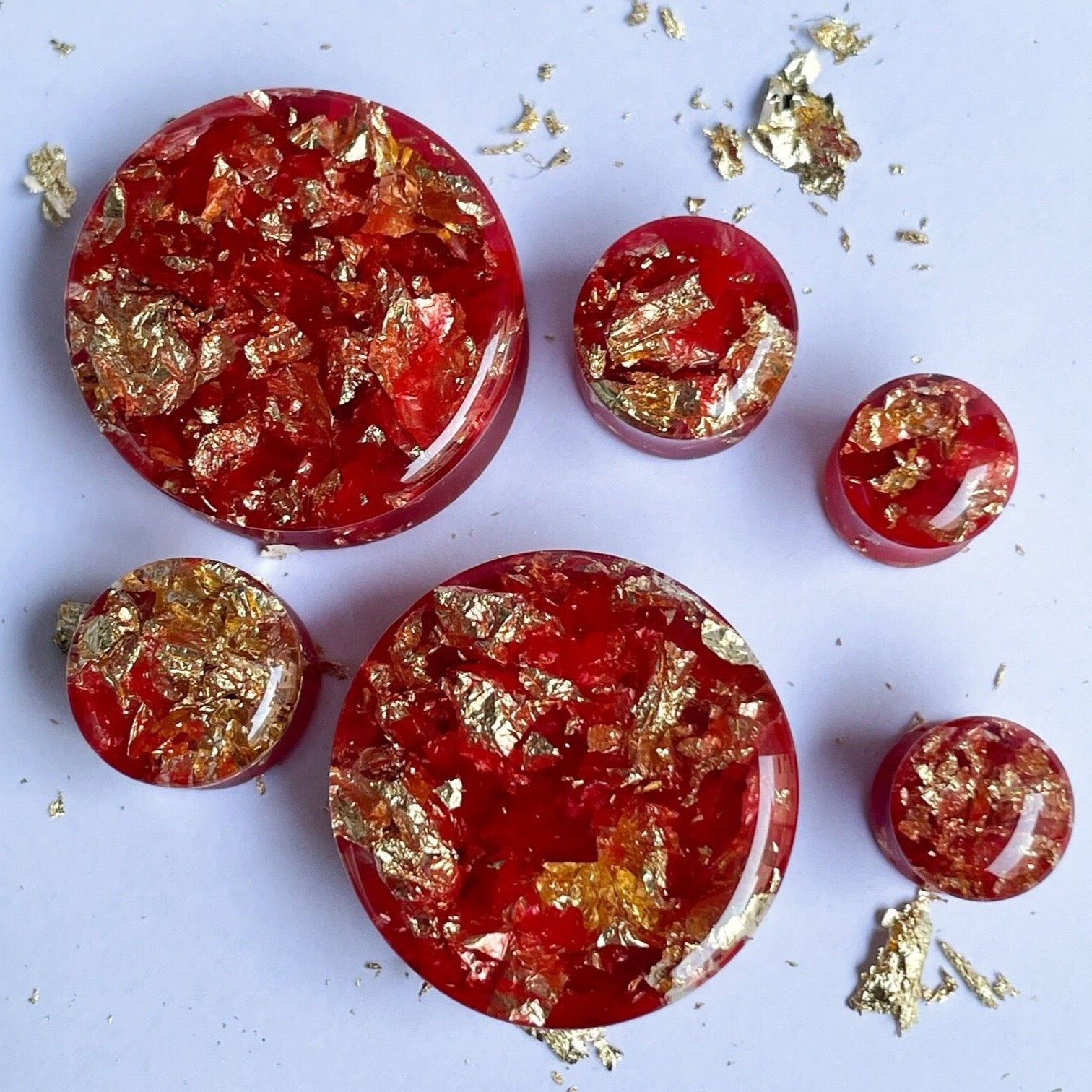 Red resin with gold colour flakes ear gauges