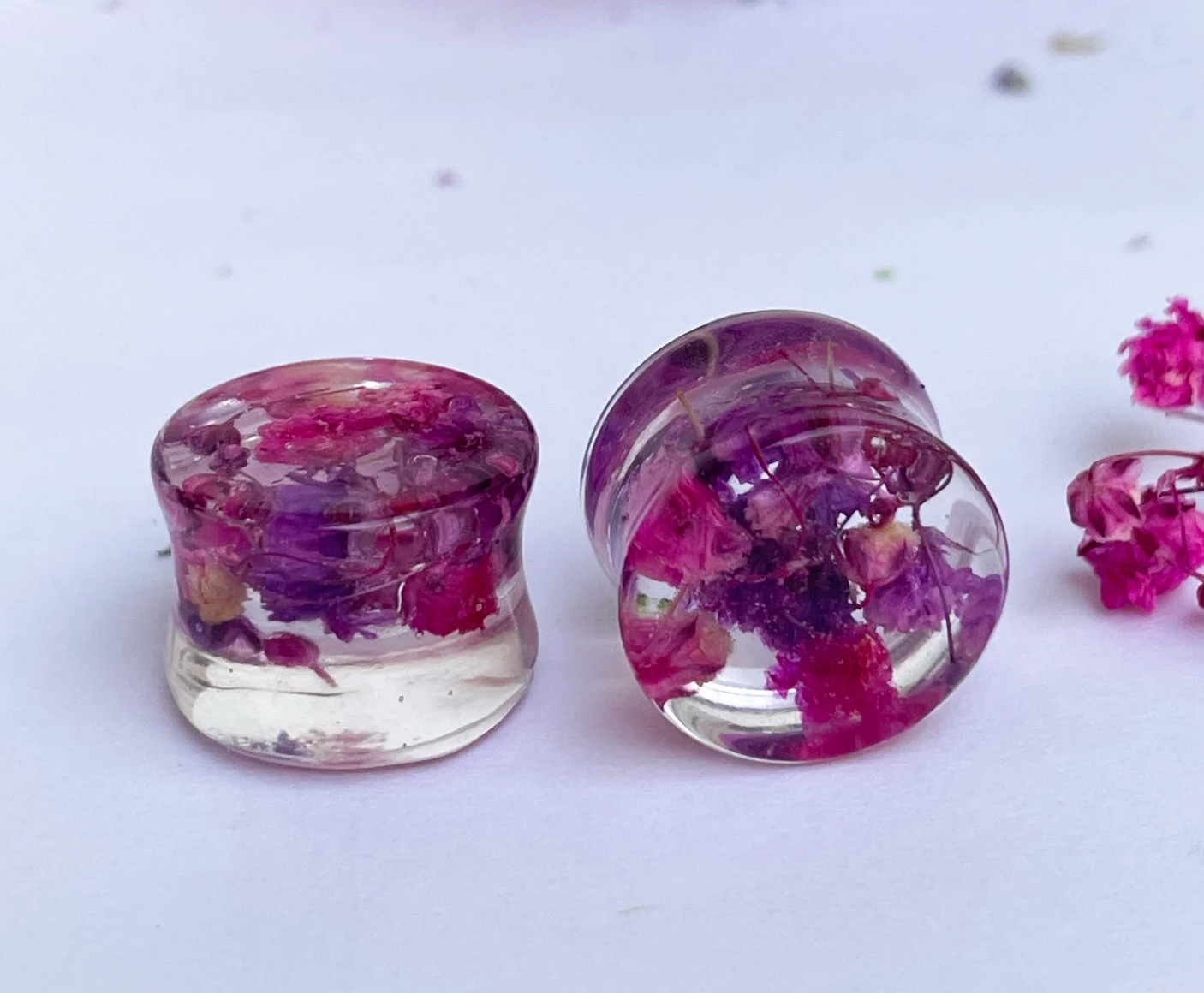 Pink and purple ear gauges