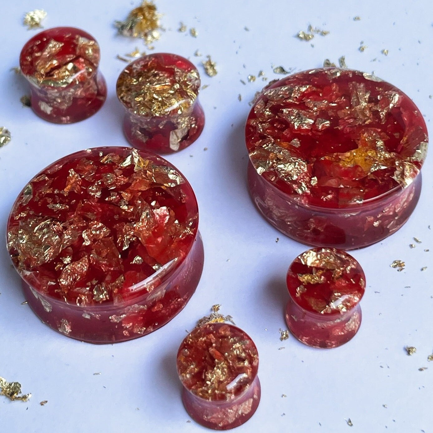 Red resin with gold colour flakes ear gauges