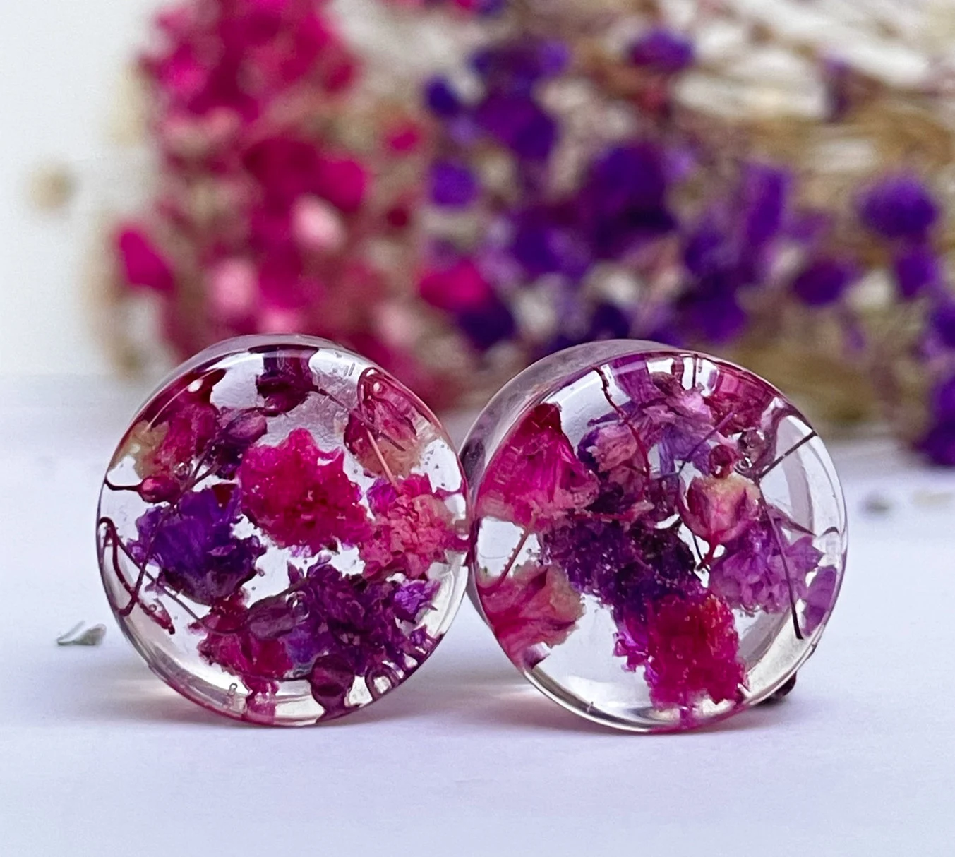 Pink and purple ear gauges