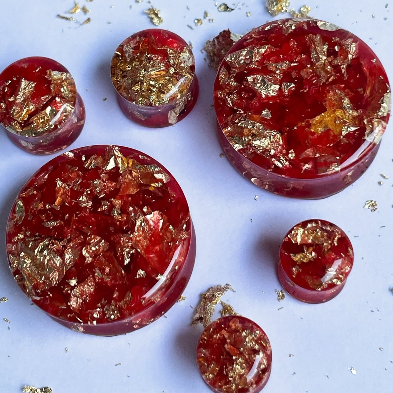 Red resin with gold colour flakes ear gauges