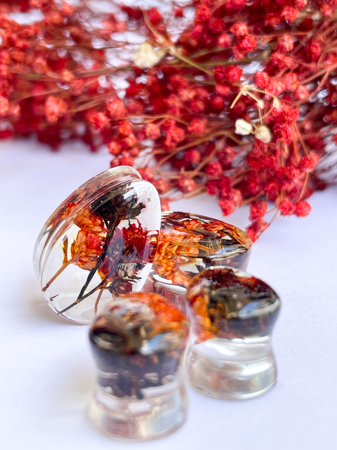 Orange and black flower teardrop ear gauges