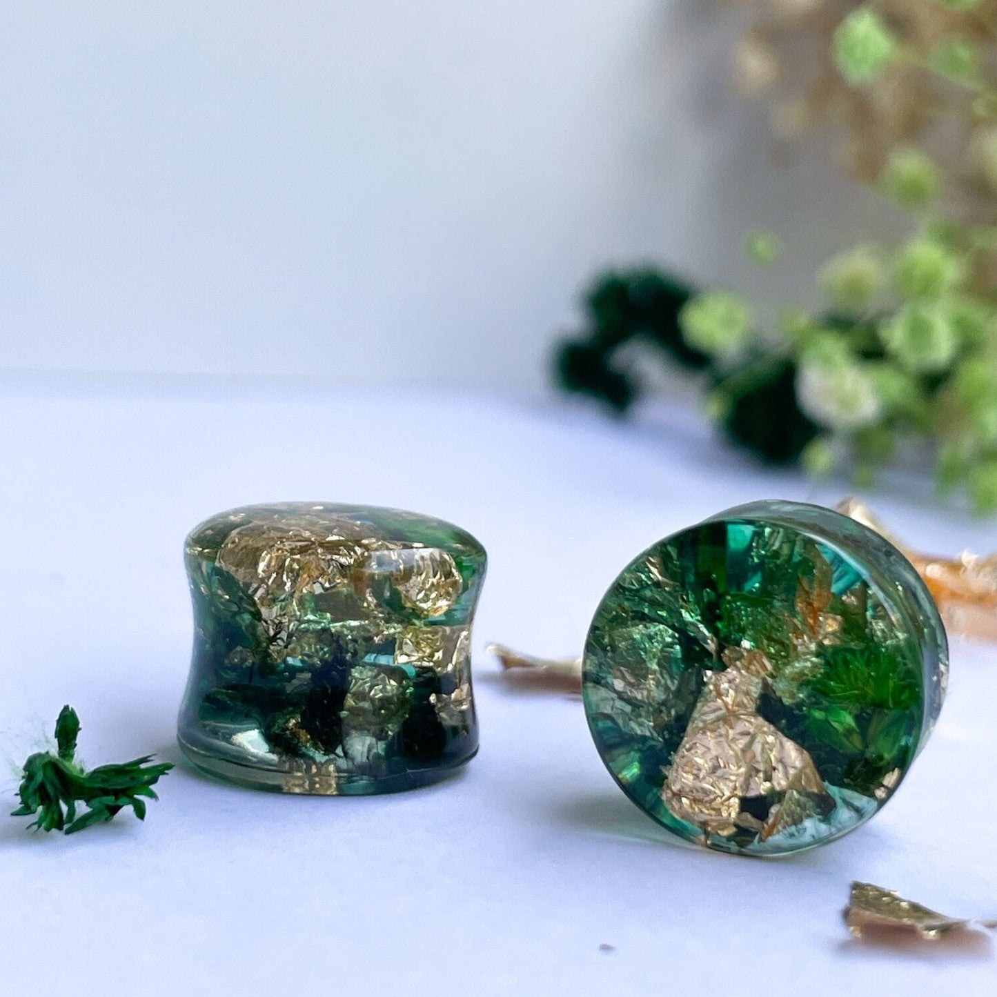 Gold flake and green colour ear gauges