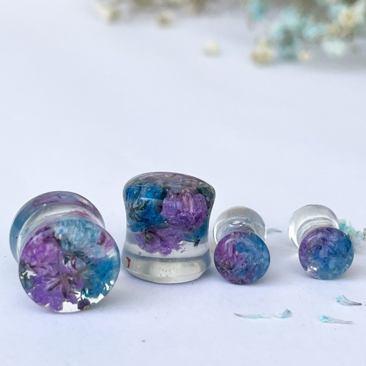 Blue and purple flower ear gauges