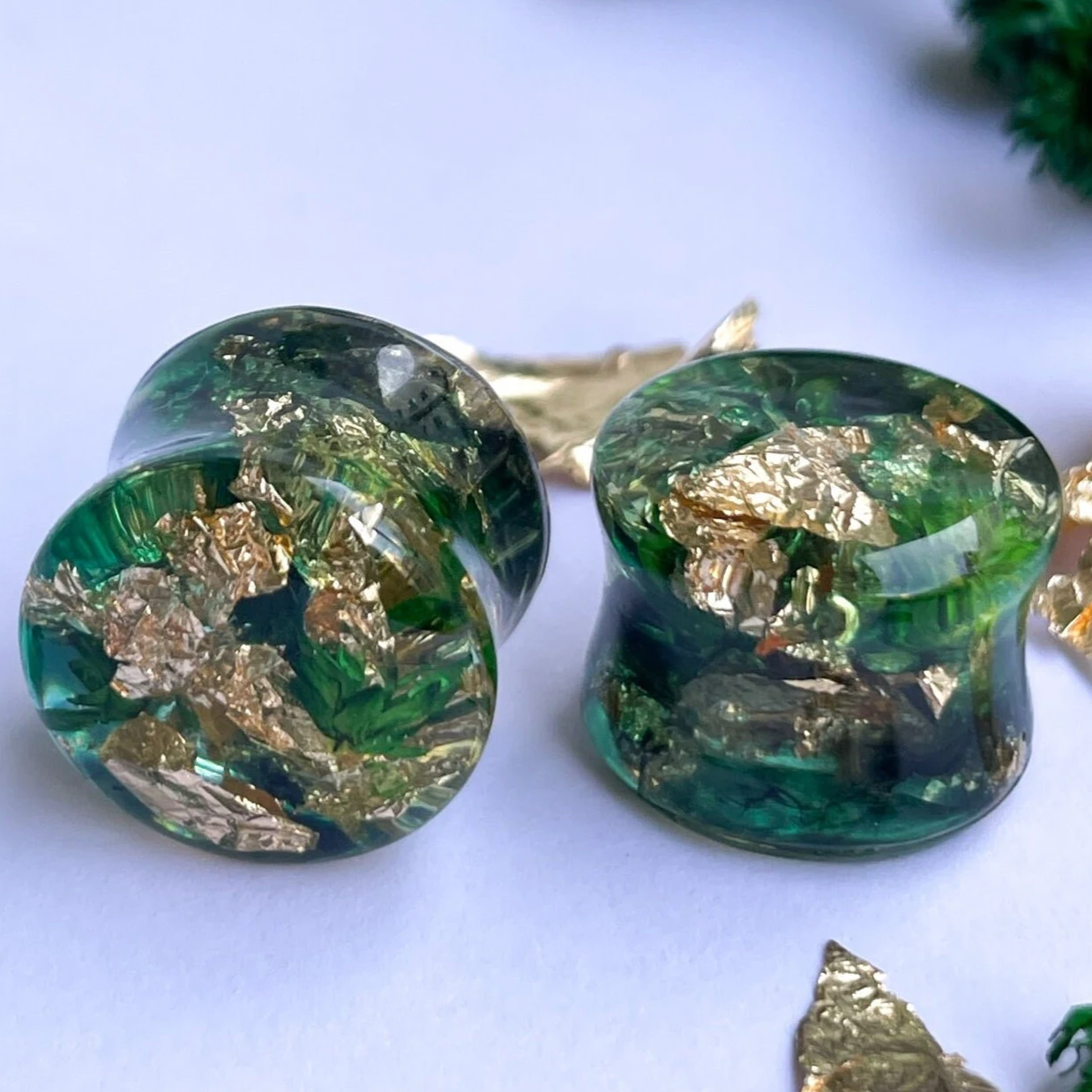 Gold flake and green colour ear gauges