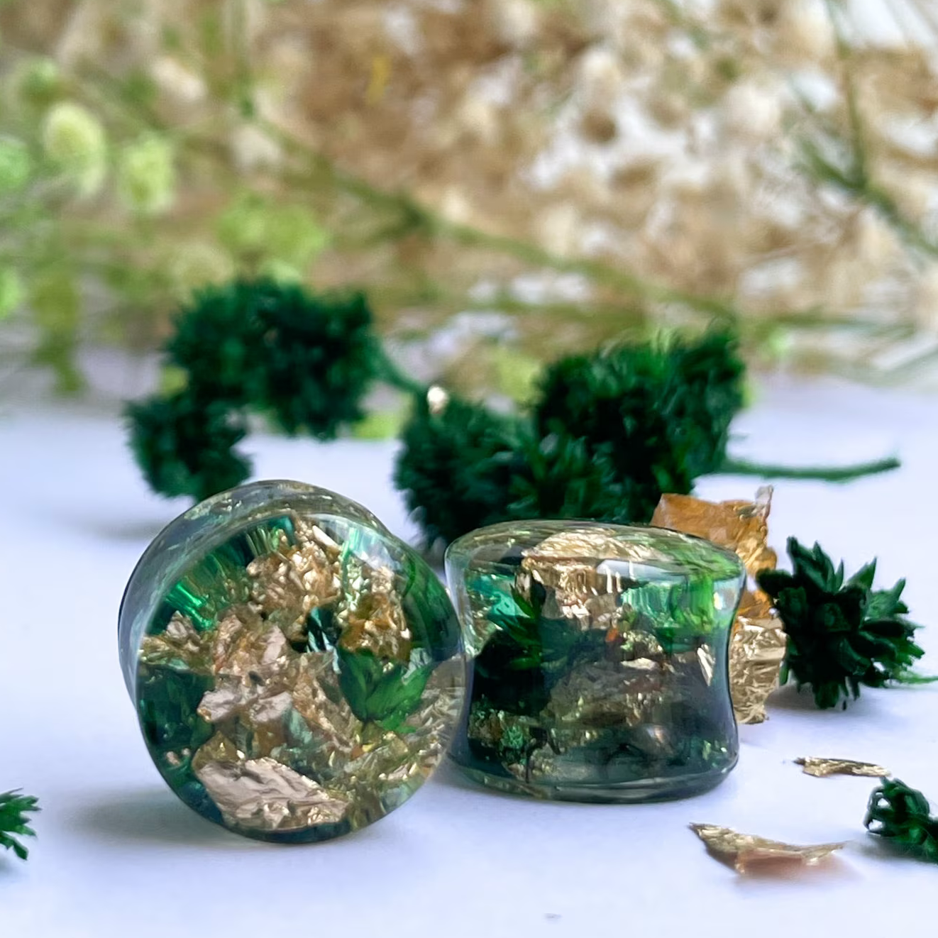 Gold flake and green colour ear gauges